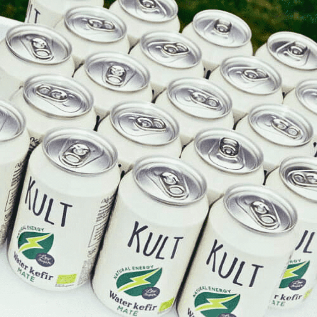 Rows of KULT Water Kefir Maté cans viewed from above